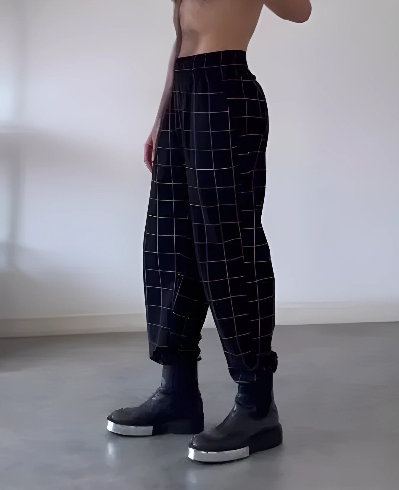 Men's plaid pattern trousers featuring an apron-style front fastening.