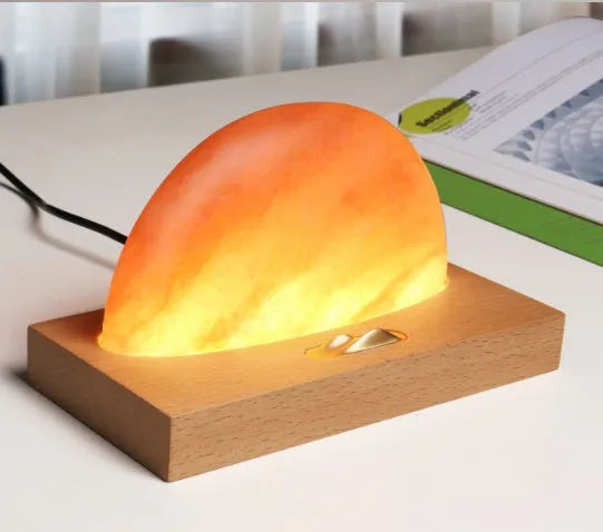 Sunrise Oriental wooden base salt lamp with wireless phone charging pad on top.