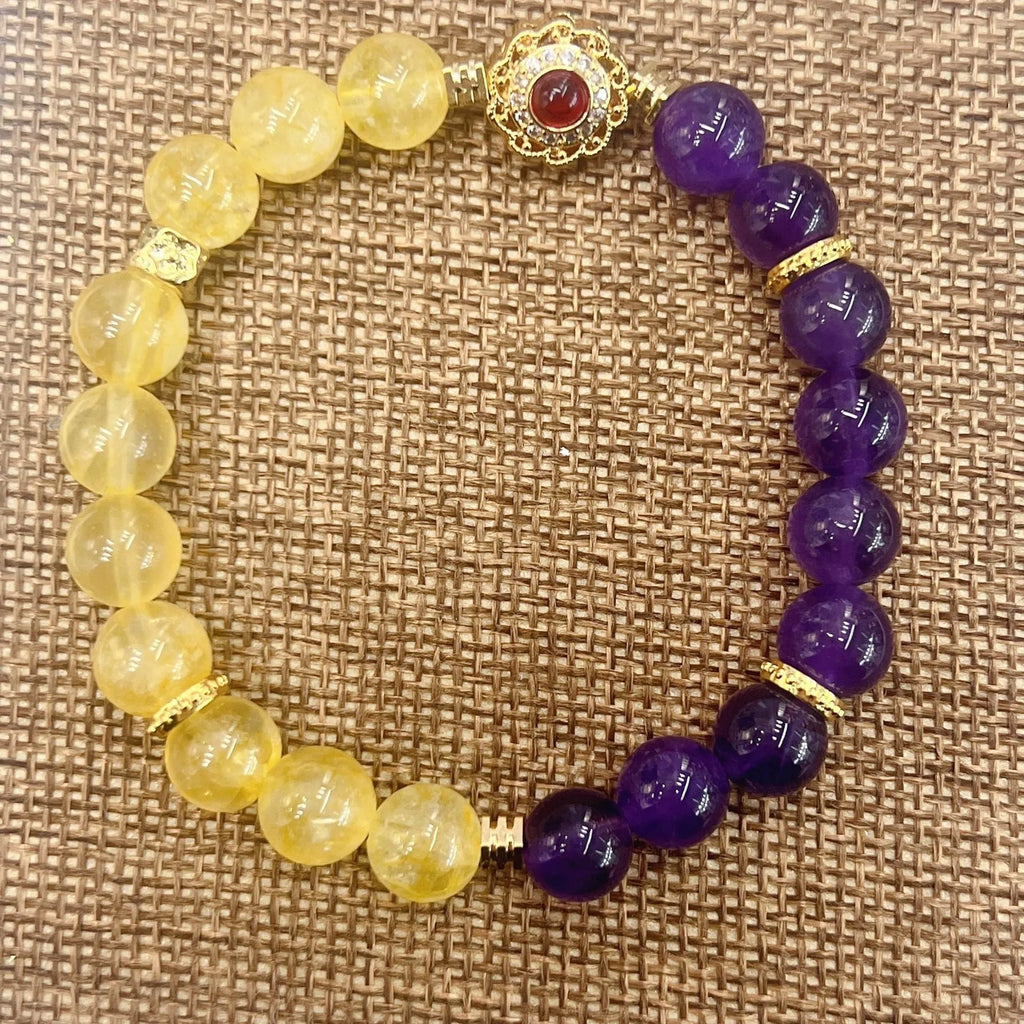 Handmade women's yellow and purple crystal bracelet with amethyst beads on wrist