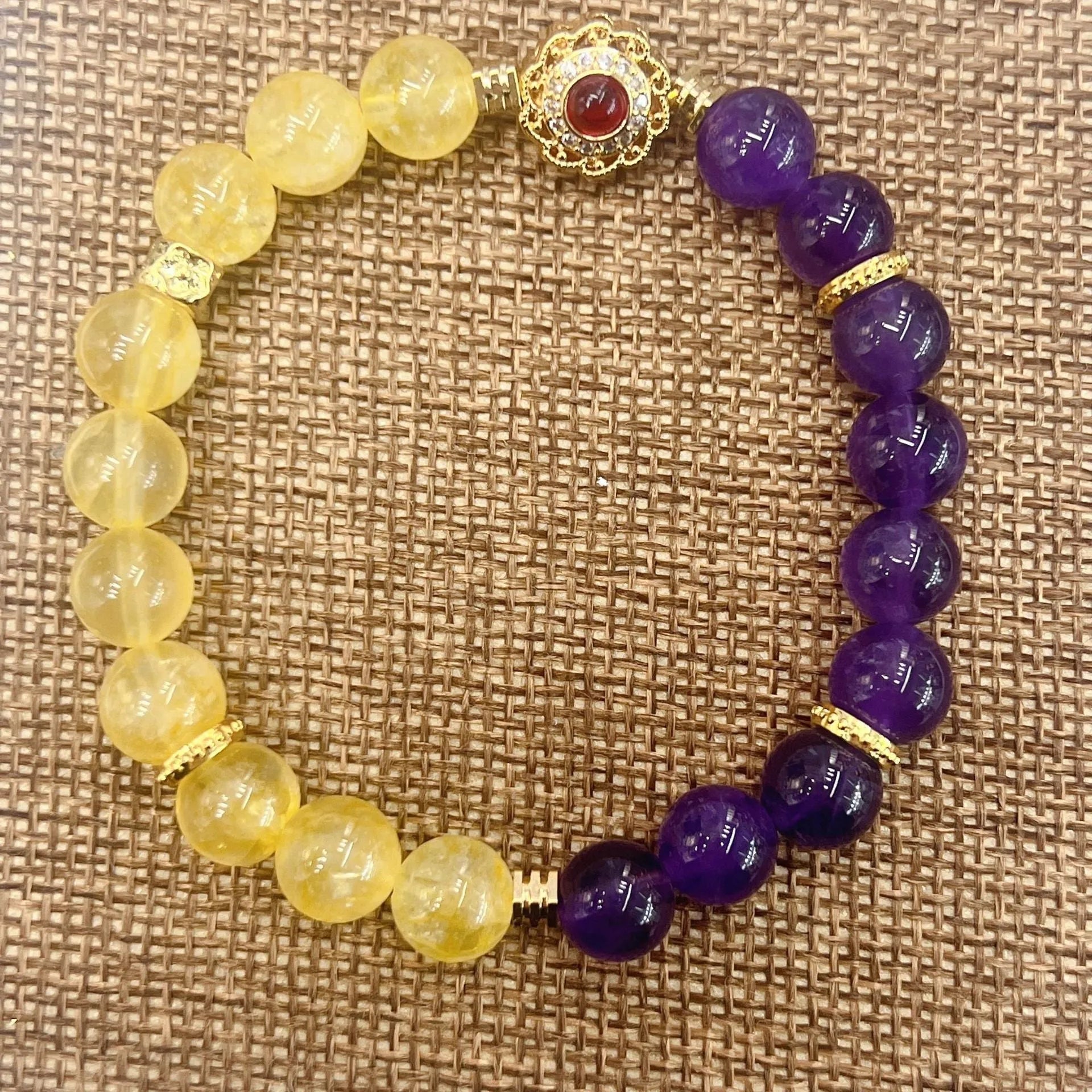 Handmade women's yellow and purple crystal bracelet with amethyst beads on wrist