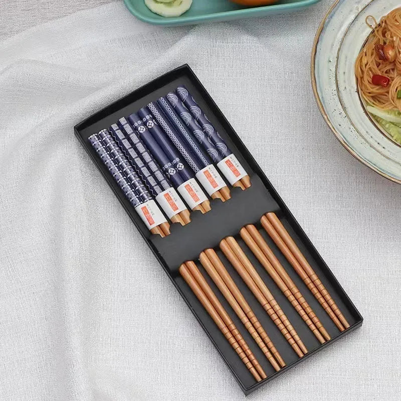 Set of five pairs of bamboo chopsticks with Japanese cartoon pattern in a gift box.
