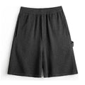 Cement grey polyester sports shorts with straight-leg design and medium elastic waistband
