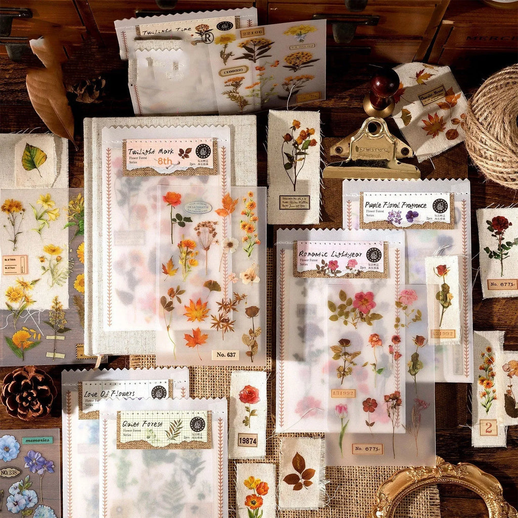 Huazhisen art sticker material pack showing printed transfer paper and cotton linen sheets in forest and romantic designs.