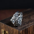 Detailed silver open ring featuring an animal zodiac beast pattern on a model's finger.
