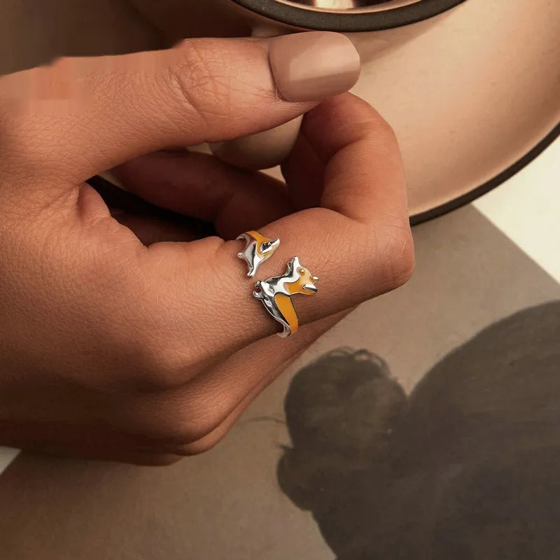 Adjustable silver ring with a raised cartoon corgi dog design on the band.