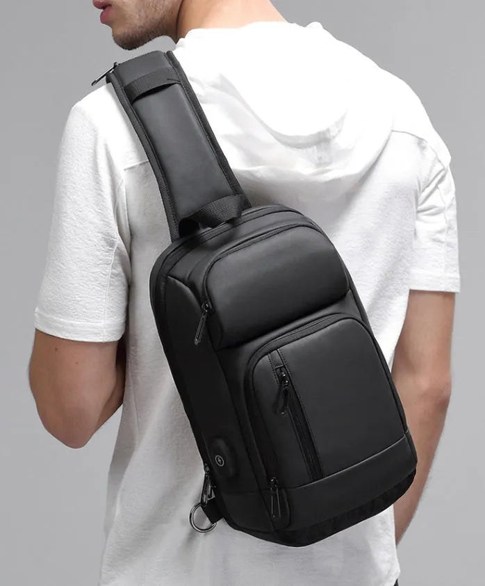 Black medium-sized PVC shoulder bag with zipper, showing internal organiser pockets and an air cushion shoulder strap.