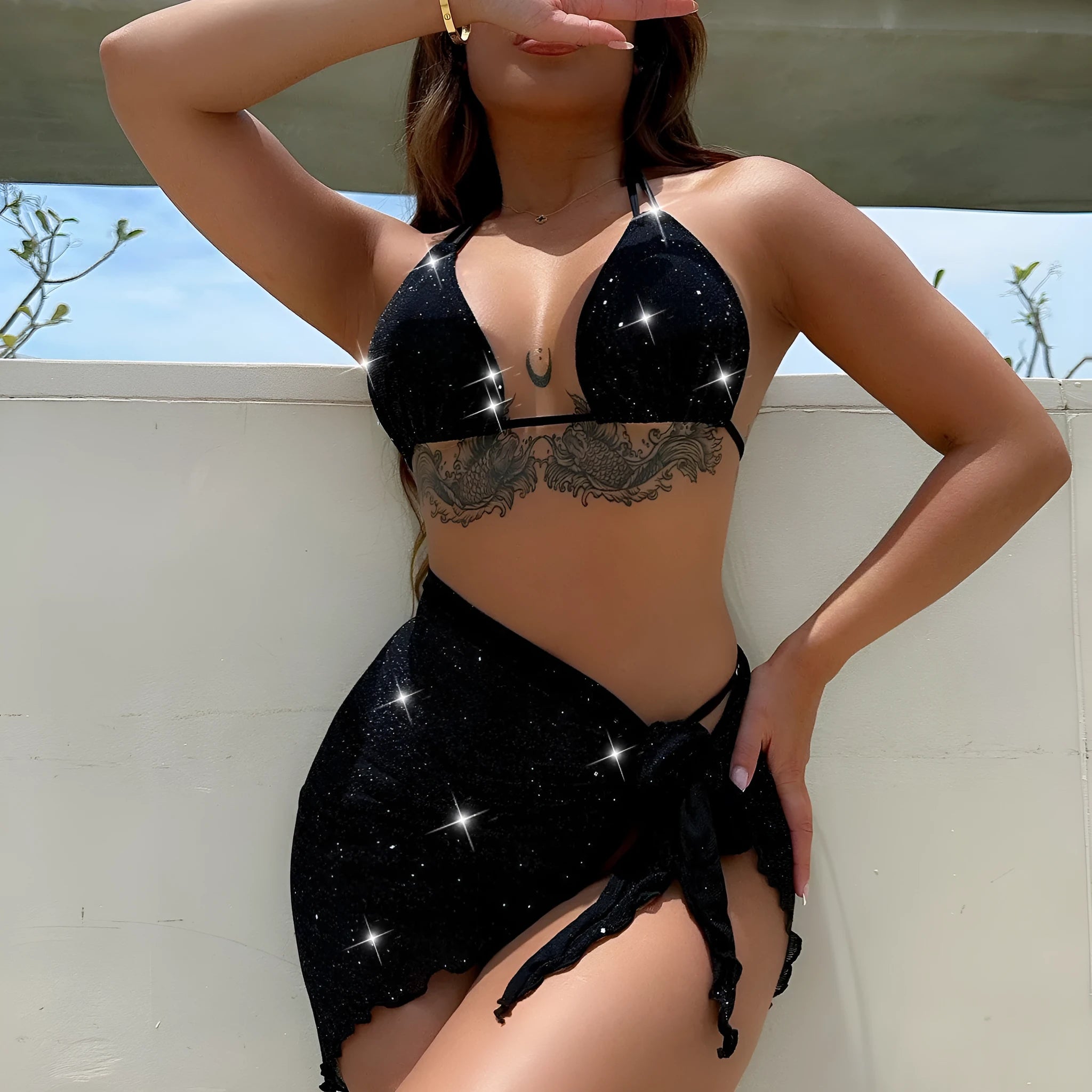 Black three-piece bikini set with bra top and shorts on a mannequin.