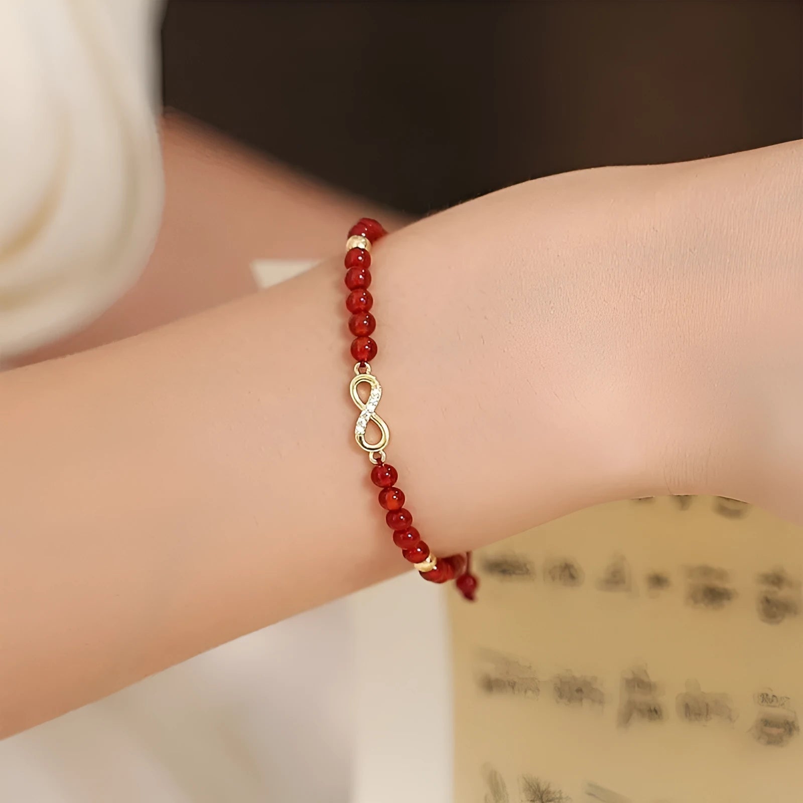 Hand-woven red agate bracelet with diamond-shaped beads and ethnic woven patterns