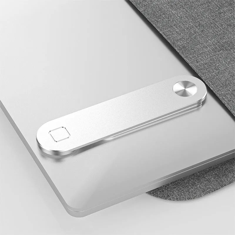 Black aluminum laptop phone holder mounted beside computer monitor showing smartphone attachment