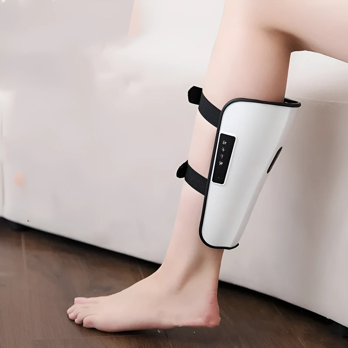 White plastic pulse calf massager with mechanical controls for infrared and electrotherapy modes.