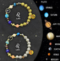 Two natural stone beaded bracelets showing zodiac sign designs on a neutral background