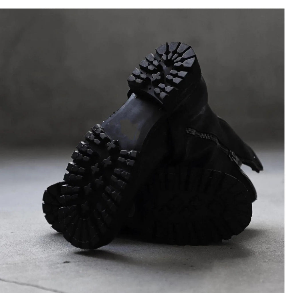 Men's black retro-style zip-up Martin boots with a round toe on a plain background.