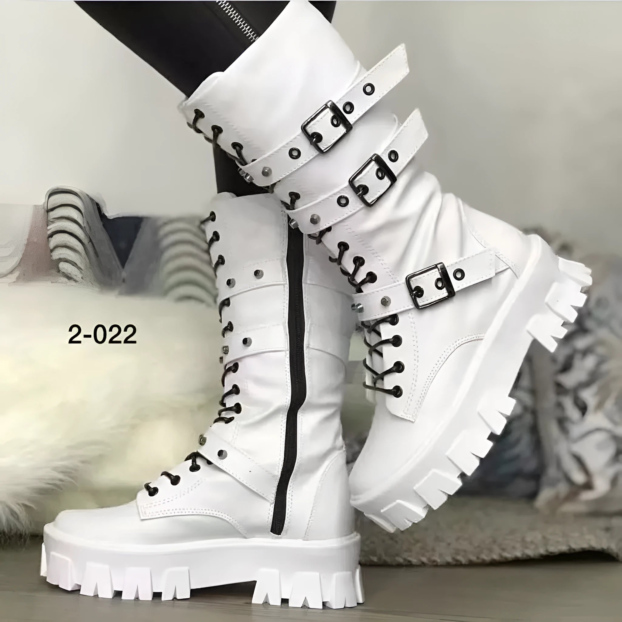 Women's black mid-calf knight boots with a large metal buckle and side zip fastening