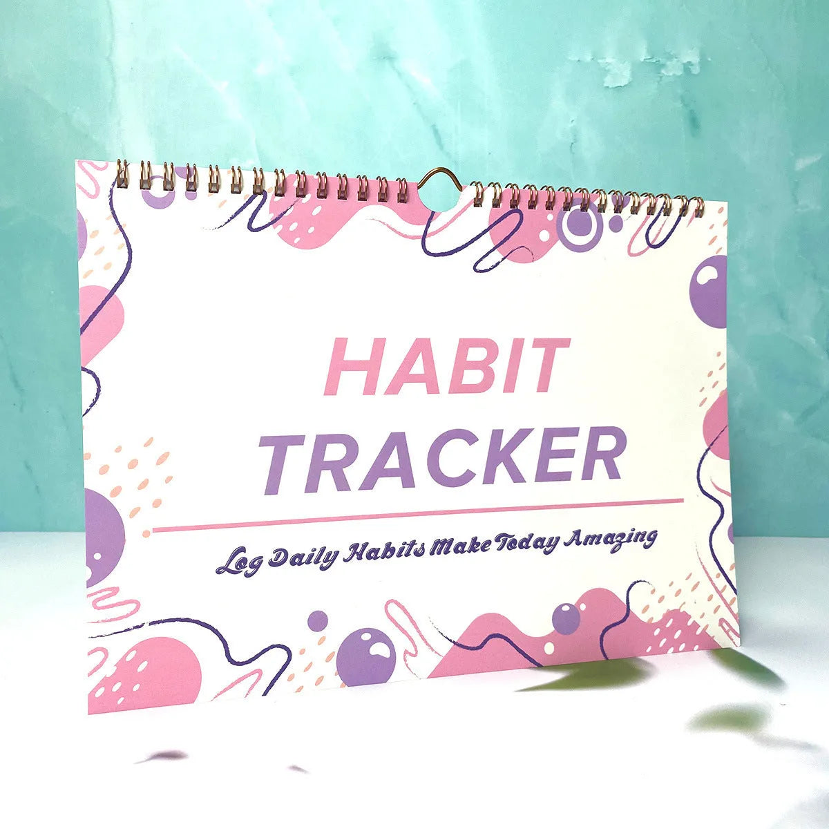English habit tracking notebook with 12 pages in 21x28cm format showing four colour options