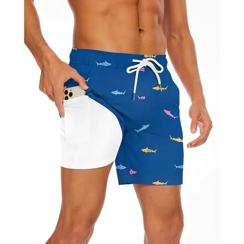 Man wearing loose light blue beach pants on shore, showing relaxed fit and casual style.
