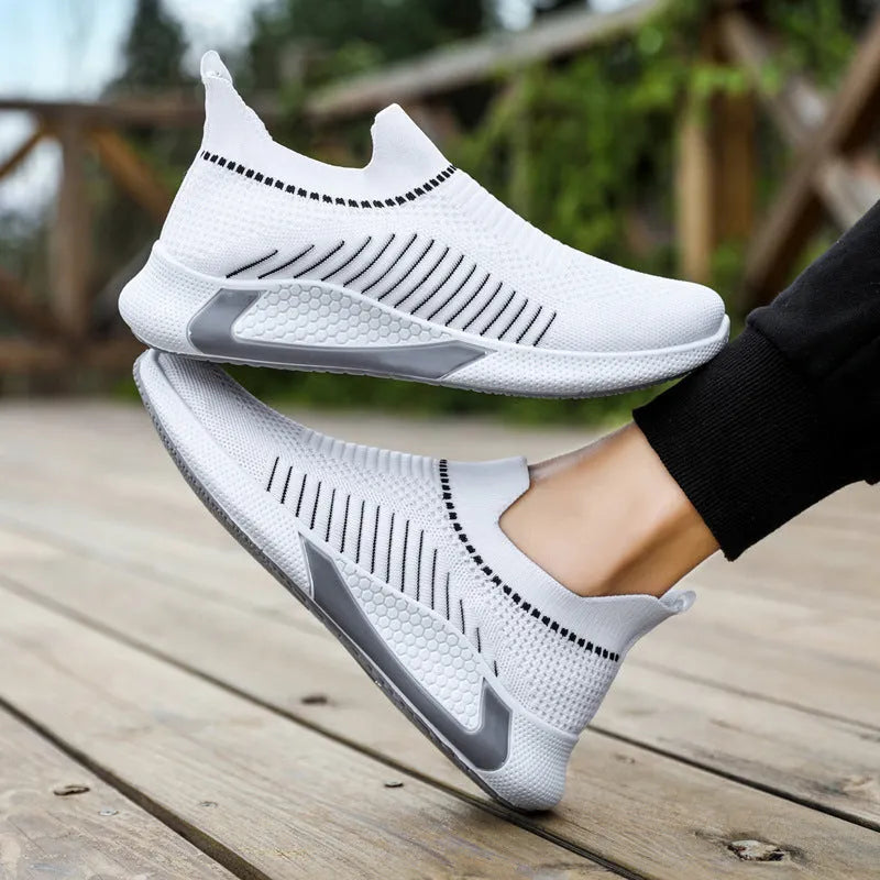 Men's black and white striped mesh slip-on sneakers with lace-up front on a white background