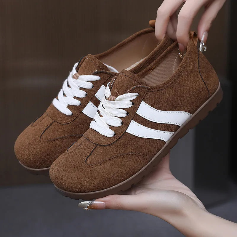 Women's vintage-style canvas sneakers with a round toe and soft rubber flat sole.