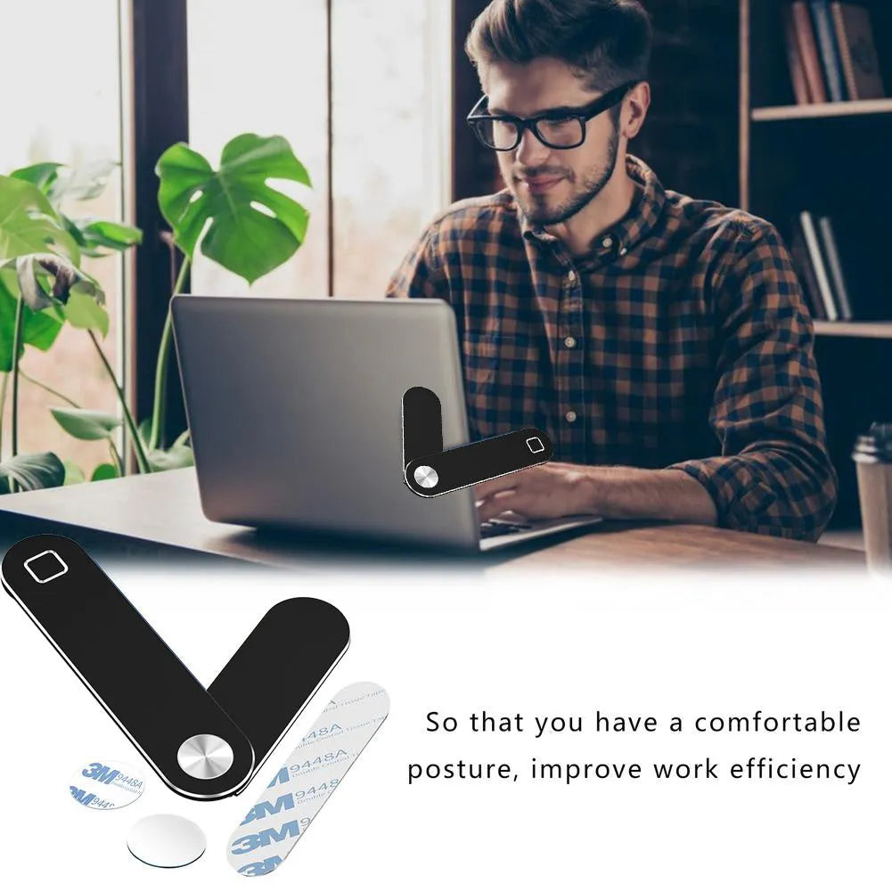Black aluminum laptop phone holder mounted beside computer monitor showing smartphone attachment