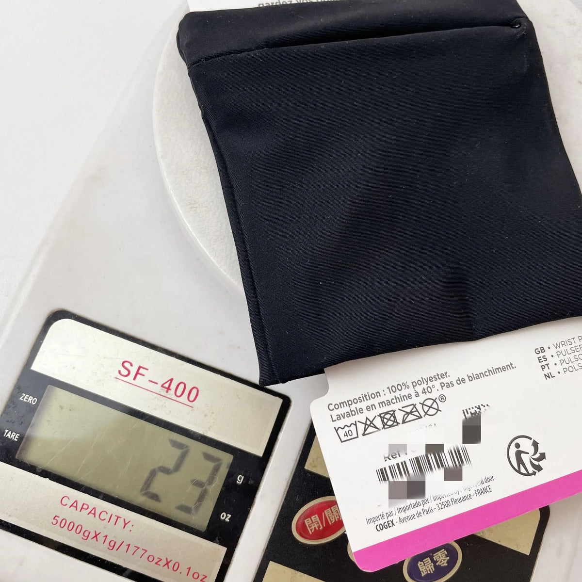 Wrist bag armband sleeve for mobile phone with adjustable strap, shown in packaging