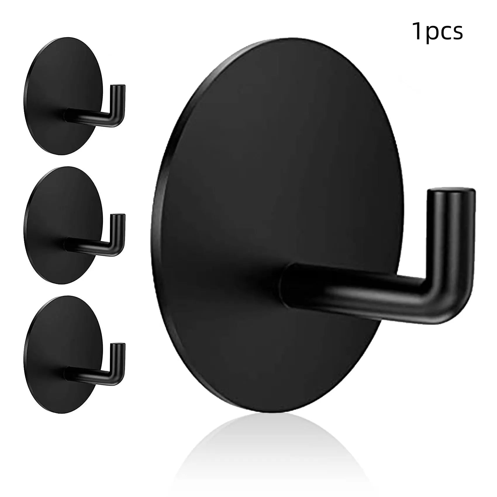 Two round stainless steel self-adhesive wall hooks, one black and one polished, on a white background.