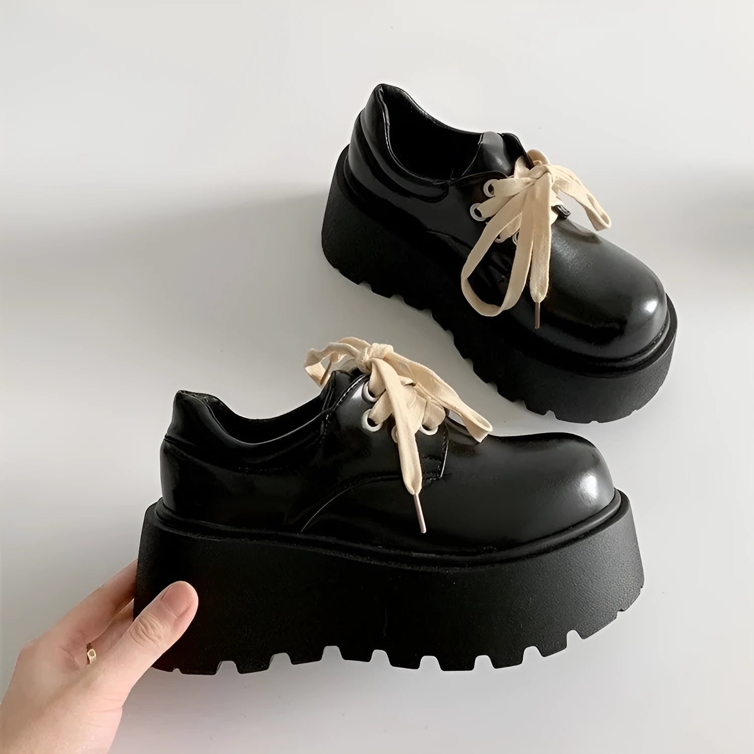 Women's matte black retro ankle boots with a thick rubber sole and buckle fastening on the side.