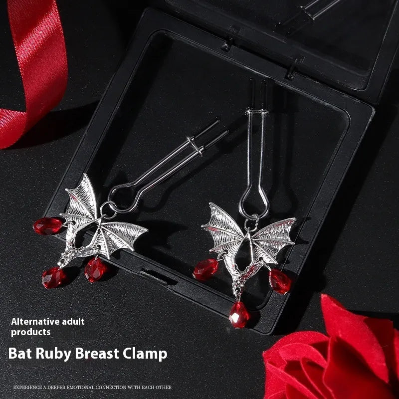 Silver bat-shaped nipple clamps with ruby accents and adjustable pressure mechanism