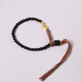 Hand-woven obsidian wrist bracelet showing 4mm width and textured strand construction