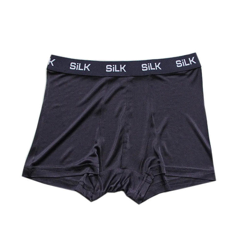 Men's loose fitting silk shorts in navy blue, shown on a mid-waist.