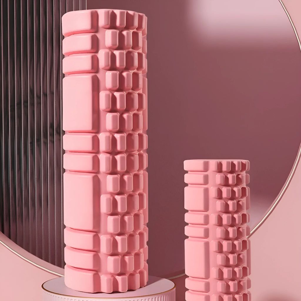 A black EVA foam roller on a floor, a fitness tool for muscle recovery and yoga.