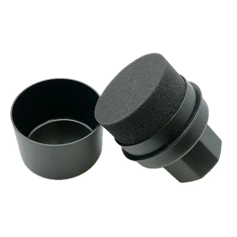 Black and red tire polishing sponge brushes with PP handles and lids on a garage workbench.