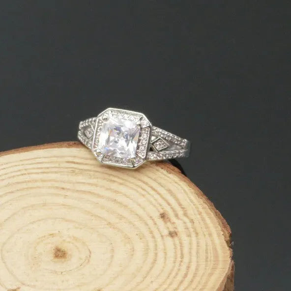 Geometric zircon ring with hollow design in platinum colour on copper, showing quadrilateral pattern and inlaid detailing