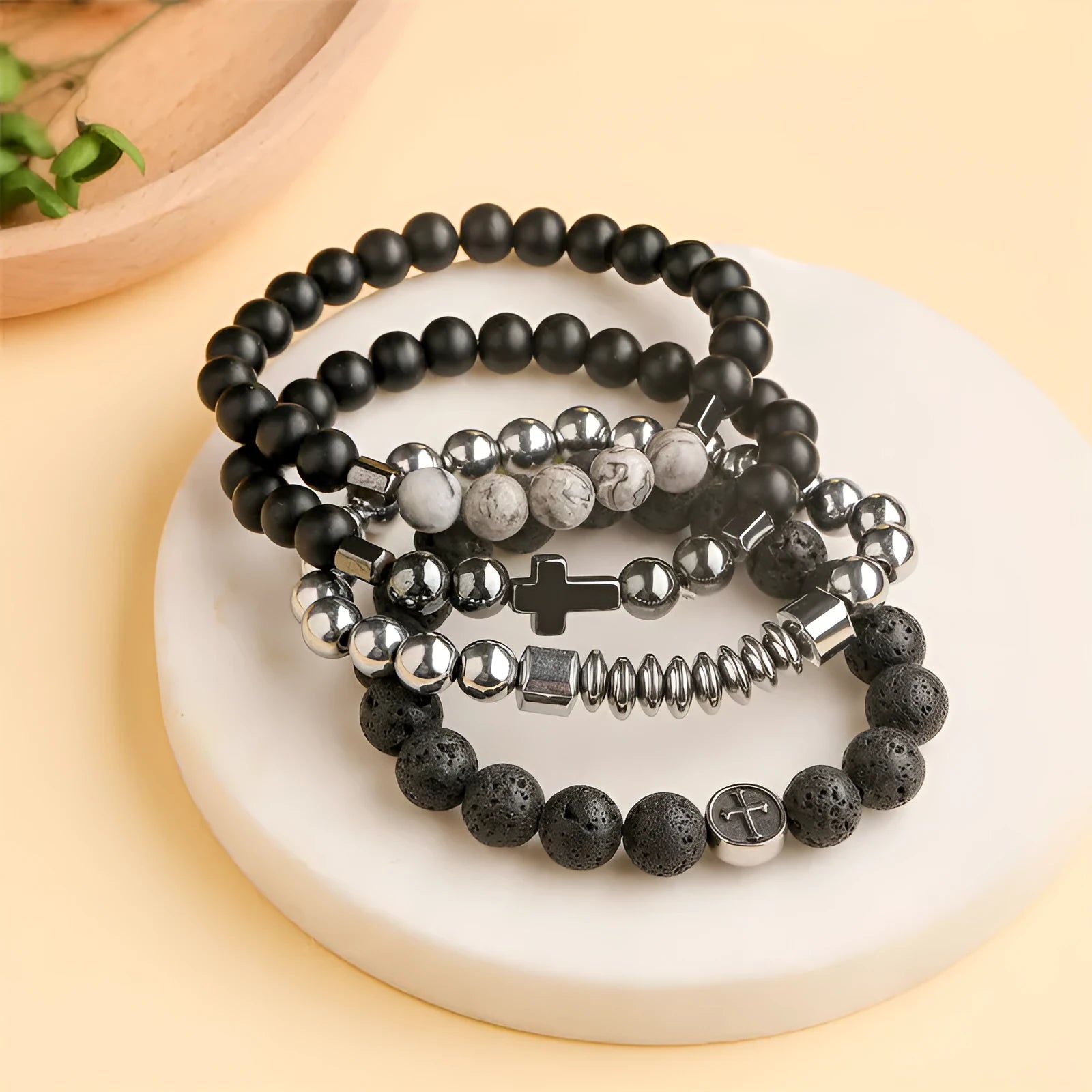 Volcanic rock agate bracelet with stainless steel geometric charm on adjustable cord.