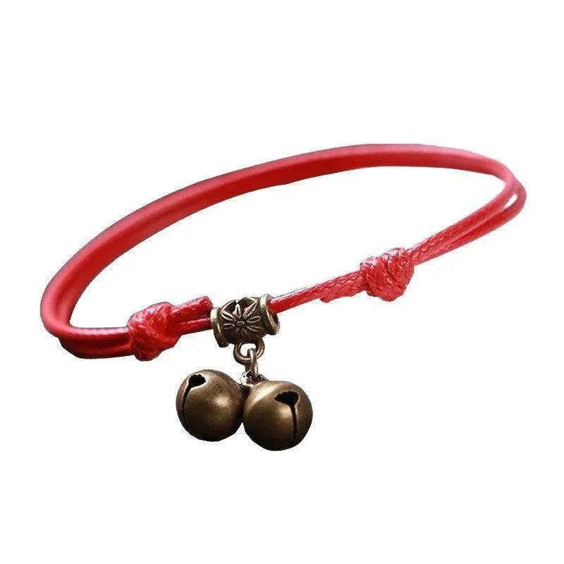 Adjustable nylon dog collar with brass bell on black rope, shown alongside red and coffee colour options.