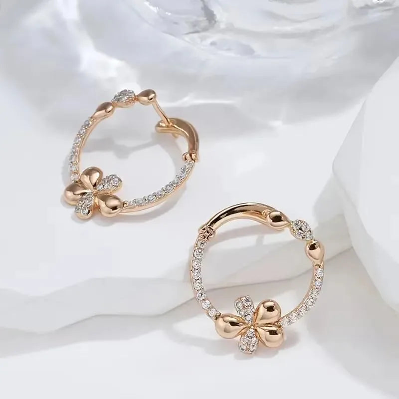 A pair of silver-colour round ring earrings for women on a white background.