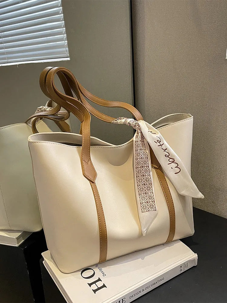 Women's soft large capacity tote bucket shoulder bag in khaki colour showing crossbody strap and front sandwich pocket.
