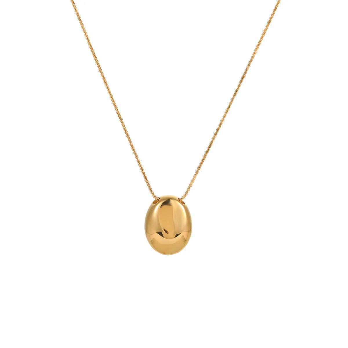 Gold geometric pendant necklace with adjustable chain on jewellery display