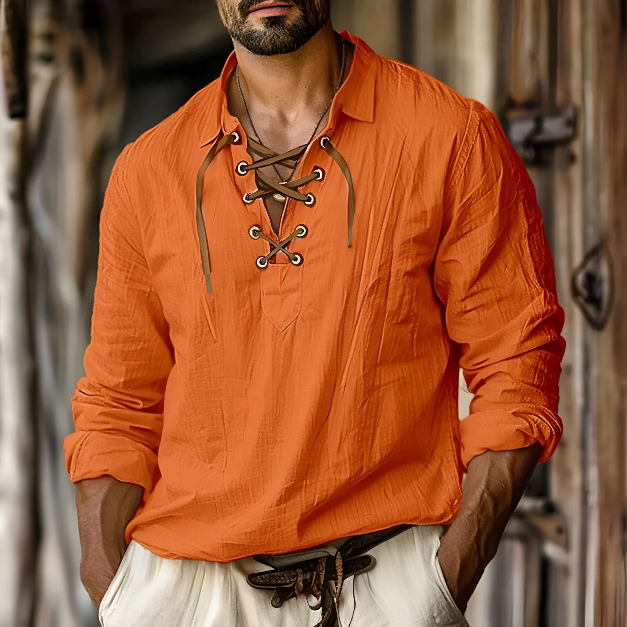 Men's loose fit long sleeve linen blend shirt in blue with a lapel collar, laid flat.