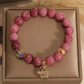 Pink lotus tassel bracelet with natural stone beads and crystal accents