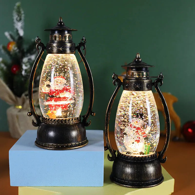 Plastic crystal ball LED oil lamp Christmas ornament with internal snowman figurine on a desktop.