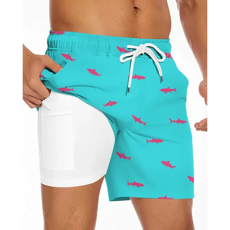 Man wearing loose light blue beach pants on shore, showing relaxed fit and casual style.