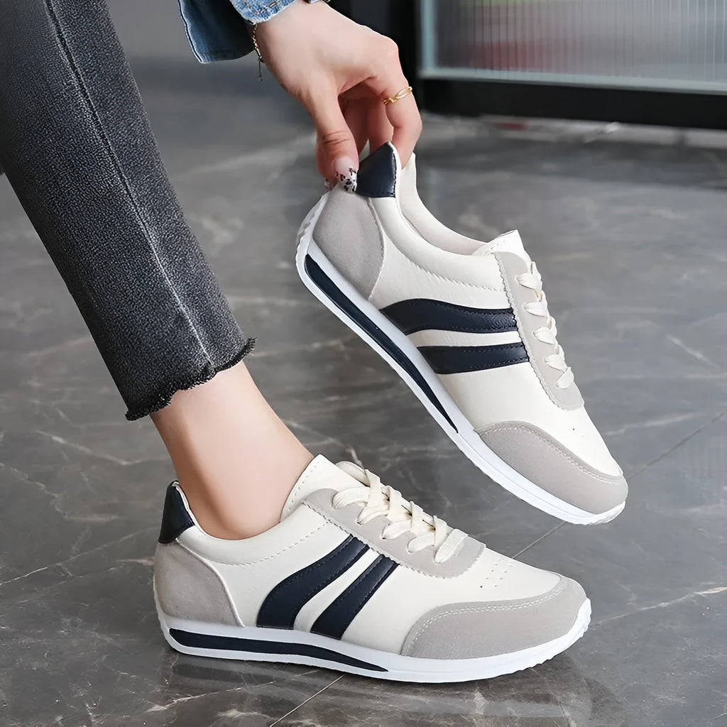 Blue and red low top lace-up leisure sneaker with a round toe and rubber sole.