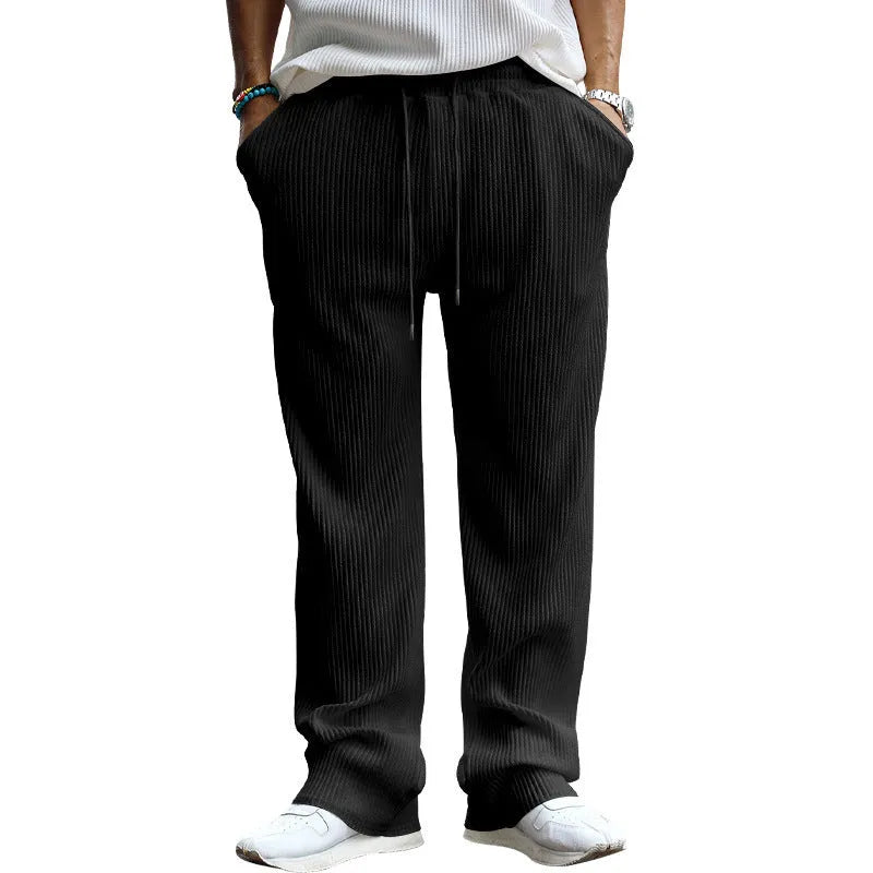 Man wearing loose fit high-waist straight leg casual trousers in Army Green.