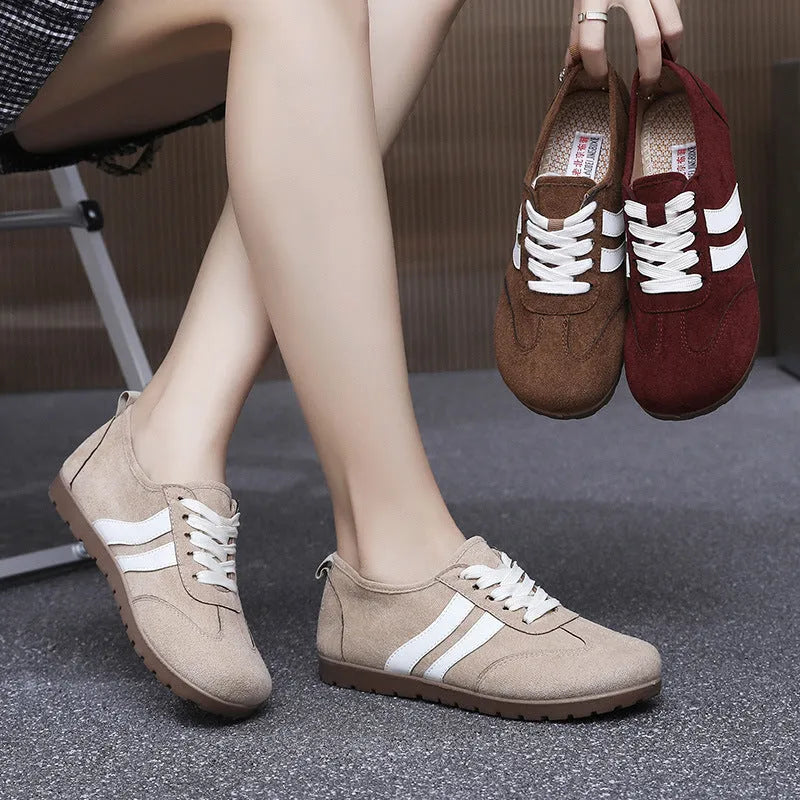 Women's vintage-style canvas sneakers with a round toe and soft rubber flat sole.