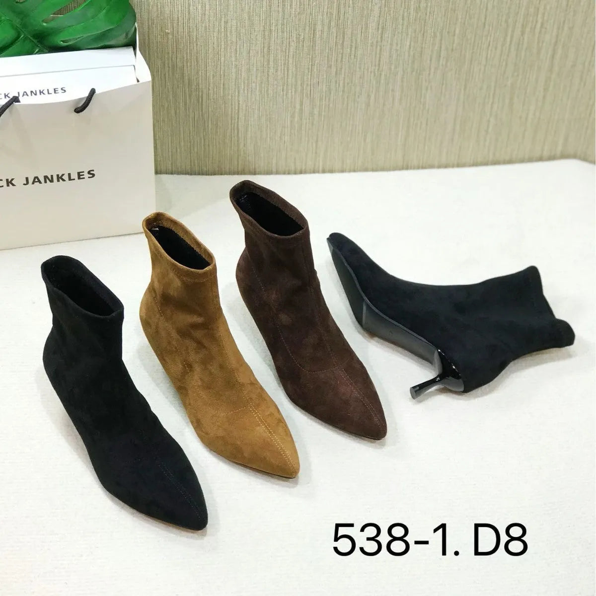 Women's black pointed toe ankle boots with stiletto heels and mid-calf length