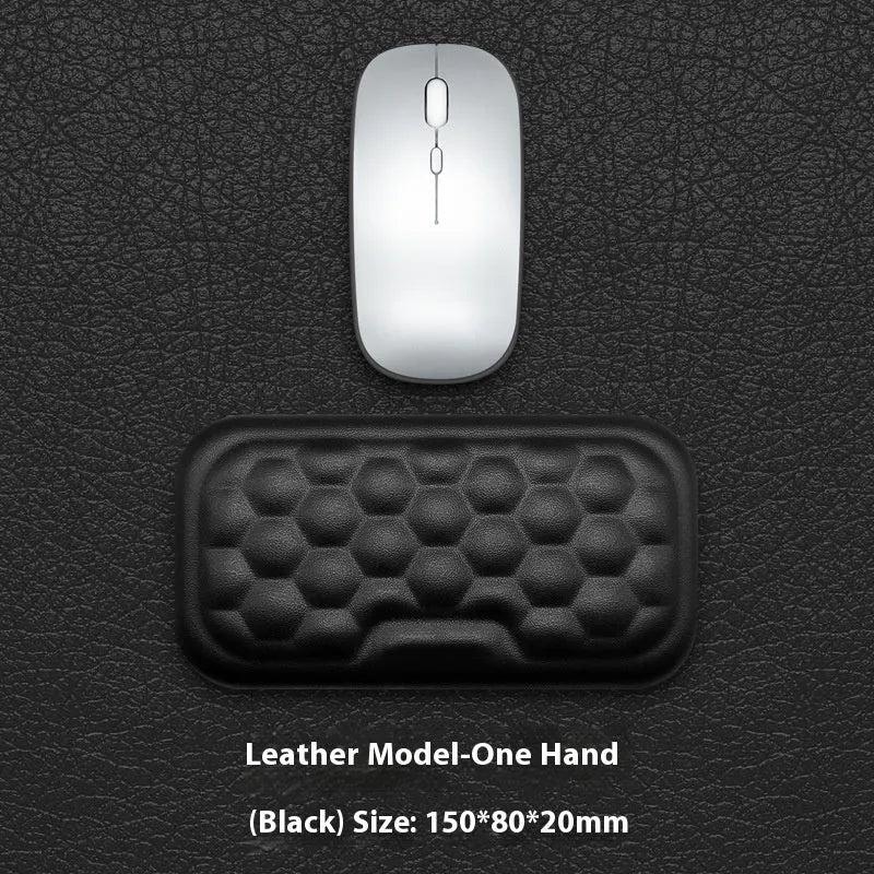 Memory foam mouse wrist pad with silicone bottom in black cloth cover on computer desk