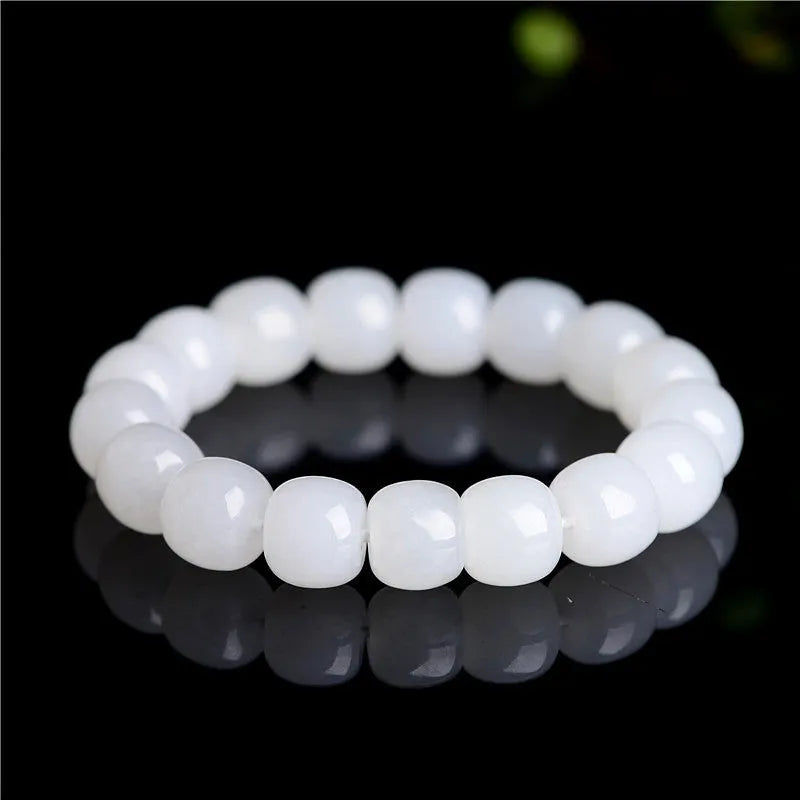 White Hetian jade barrel bead bracelet on a wrist, showing unisex casual style