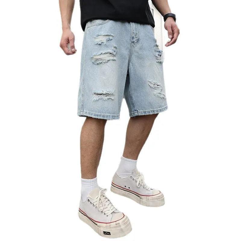 Light blue loose fit ripped denim shorts with distressed detailing and a straight leg cut