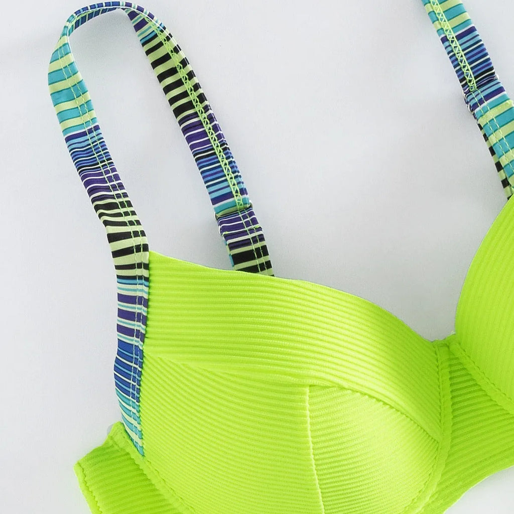 Green printed women's bikini set with halter triangle top and split briefs on white background