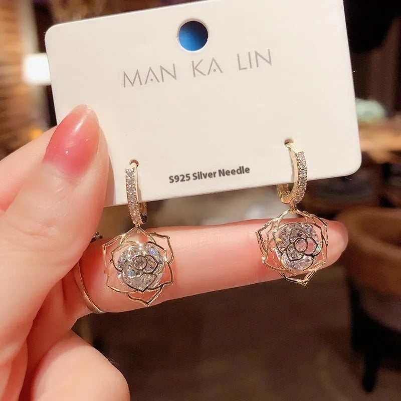 Geometric rose design copper earrings with zircon stones in an electroplated colour finish.