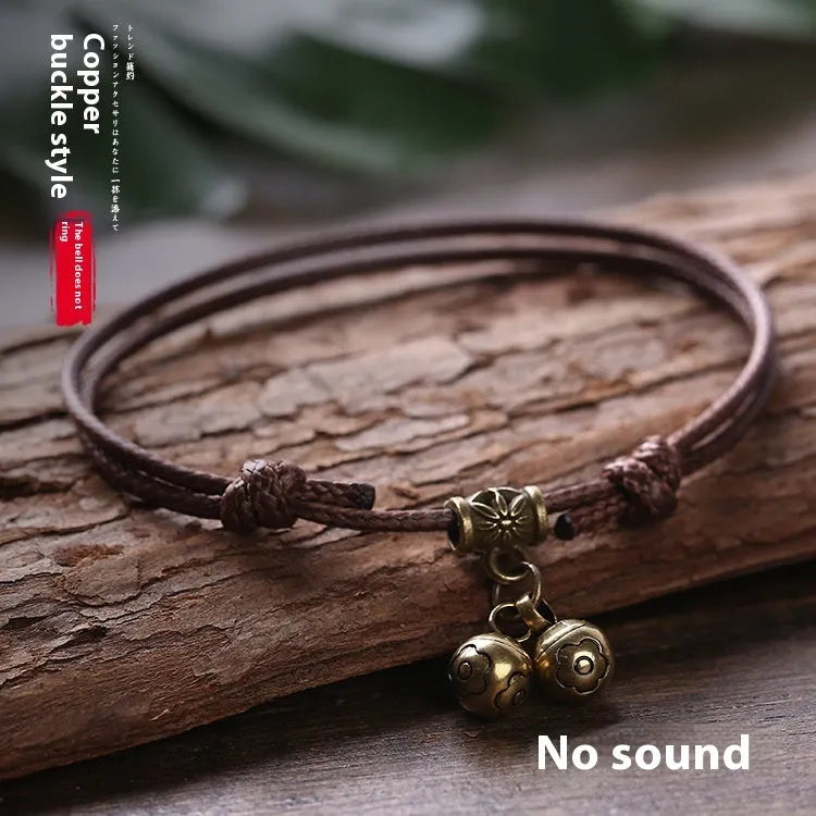 Adjustable nylon dog collar with brass bell on black rope, shown alongside red and coffee colour options.